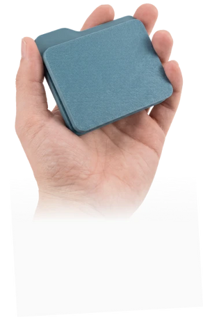 Hand holding a plain 3D printed SD card storage case before laser engraving and customization.