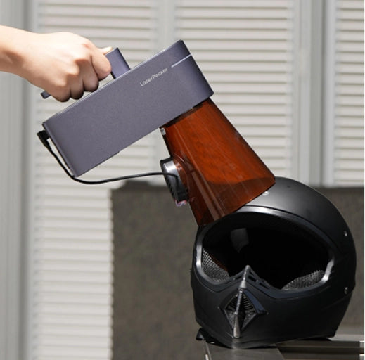 Handheld LaserPecker LP4 engraving at a unique angle on an irregular object.