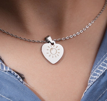 Custom heart-shaped metal pendant with a personalized laser engraving by LaserPecker LP4.
