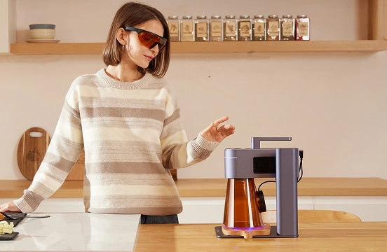 A home DIY enthusiast wearing laser safety goggles to safely operate the LaserPecker LP4 laser engraver.