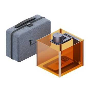 LaserPecker engraver complete kit, including an amber safety enclosure, a protective carrying case, and a free 3-piece materials kit, enabling safe, portable, and immediate engraving projects.