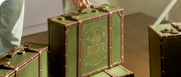 Vintage-style suitcases displayed on a wooden table.