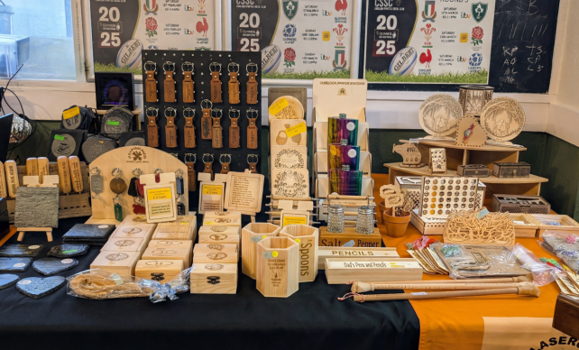 Multiple wooden engraved items displayed on a table.