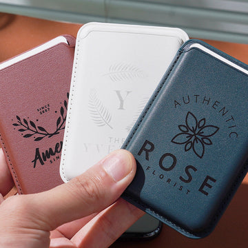 Three slim, faux leather card holders, each laser-engraved with a unique custom design.These compact, stylish card holders demonstrate how laser engraving can transform functional accessories into branded gifts.