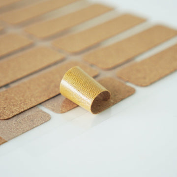 peeling backing off rectangular cork label sticker showing self adhesive for easy application on bottles.