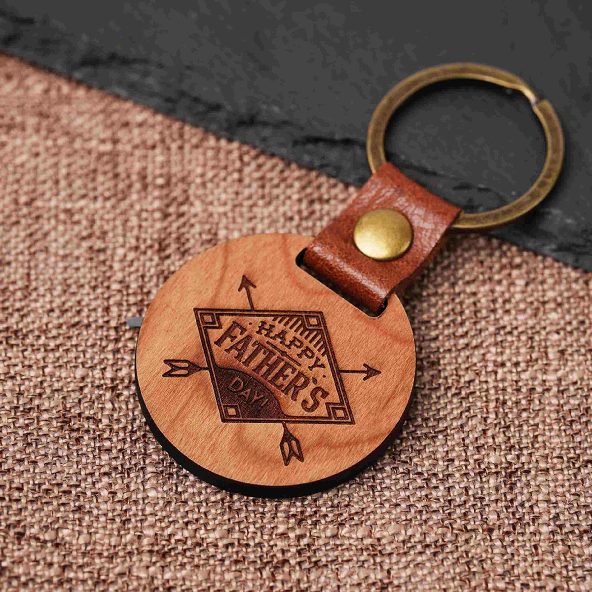 cherry wood circular keychain with laser engraved name and heart for personalized gift for fathers day.
