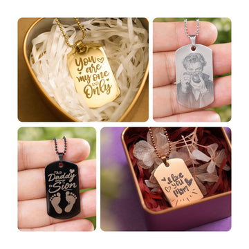 A collage of four personalized stainless steel dog tag necklaces, showcasing diverse engraving options: a gold tag with the phrase "You are my one and Only" in a heart-shaped gift box, a silver tag with a detailed laser-engraved portrait, a black tag with "This Daddy belongs to Sion" and baby footprints, and a rose gold tag with "I love you Mom" in a decorative gift box.